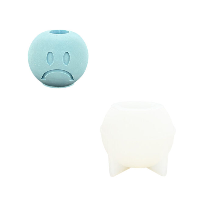 Silicone mould for casting a Jesmonite candle holder with sad face design