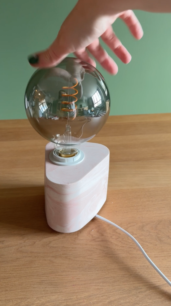 Adding the bulb to the finished Jesmonite lamp